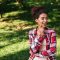 pretty-young-african-woman-sitting-outdoors-park (1)